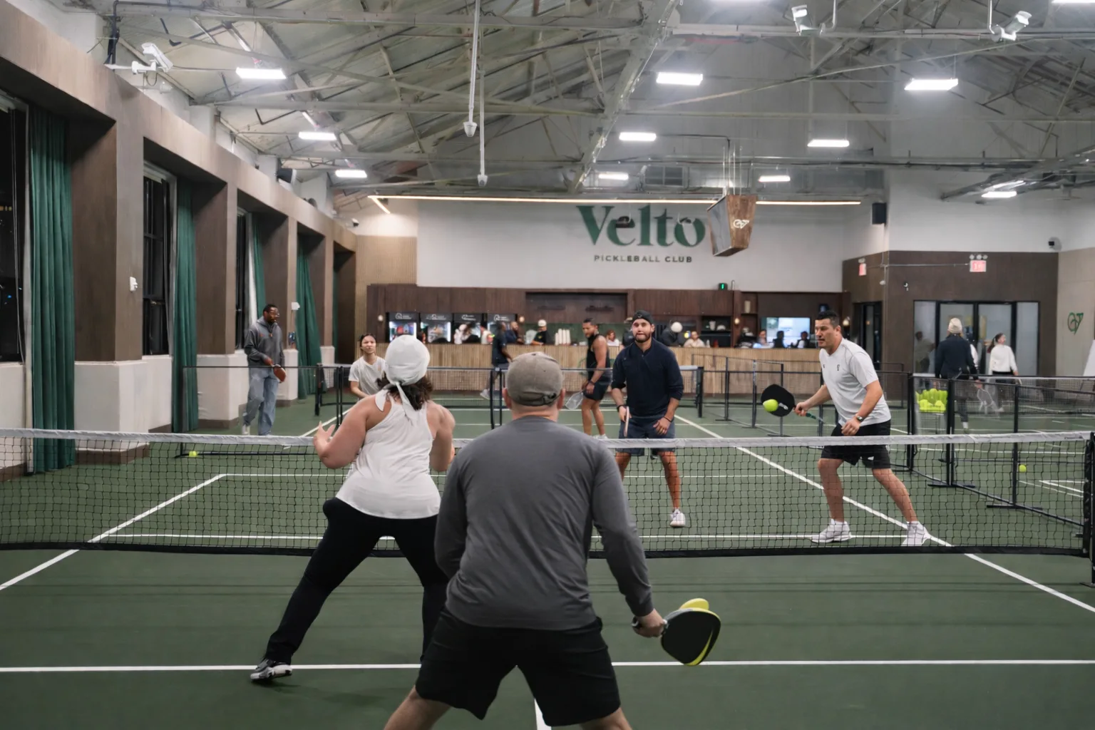 Players during a doubles match with Velto sign